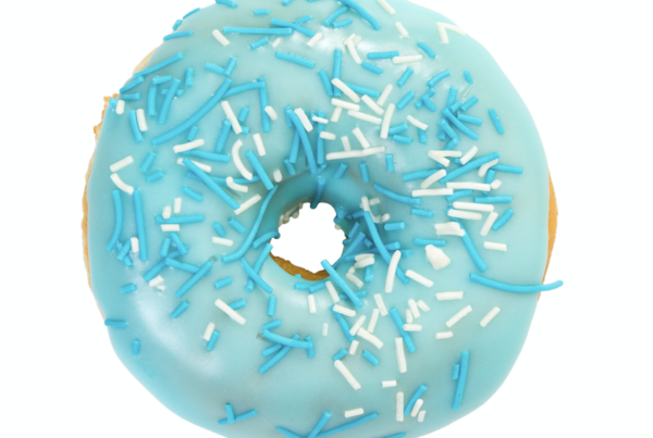 A delicious donut topped with vibrant light blue frosting, colored with BioconColors natural blue colorant derived from Spirulina or Huito.